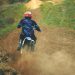 Man Riding Motocross Dirt Bike on Dirt Road
