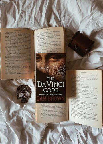 Opened Books on White Bedding