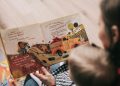 Woman Reading Book to Toddler