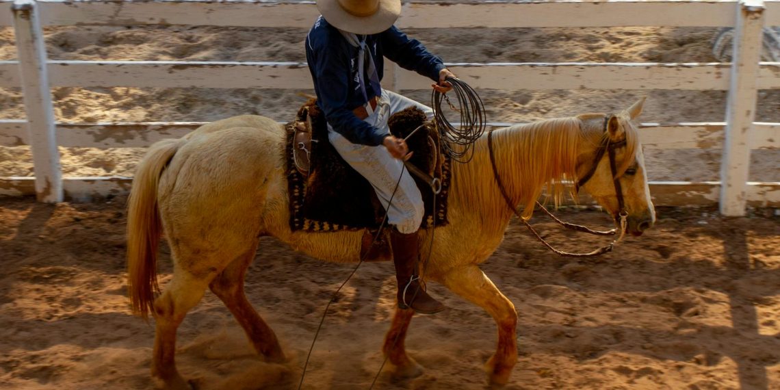 Brazilian Cowboy Riding Horse in Arena
