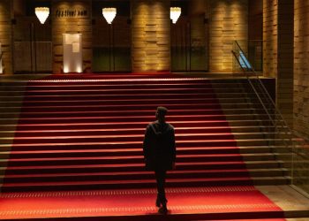 Dark silhouette in hall with red carpet