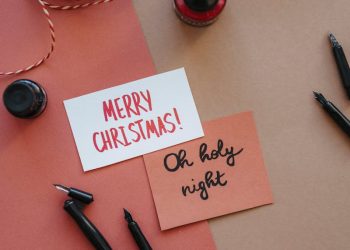 Black Fountain Pen Beside Pink and White Merry Christmas Greeting Card