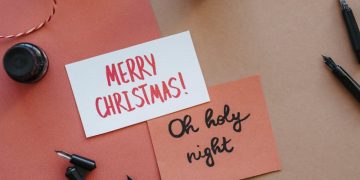 Black Fountain Pen Beside Pink and White Merry Christmas Greeting Card