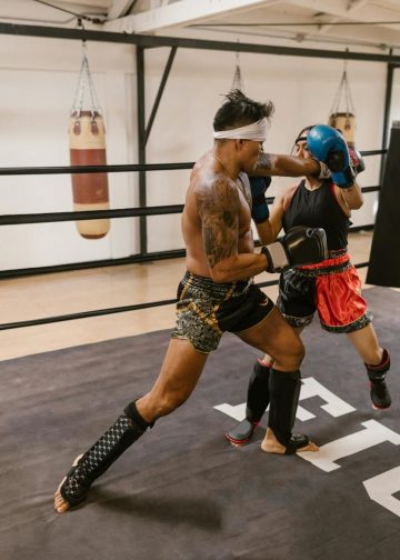 A Man and a Woman Doing Boxing Training
